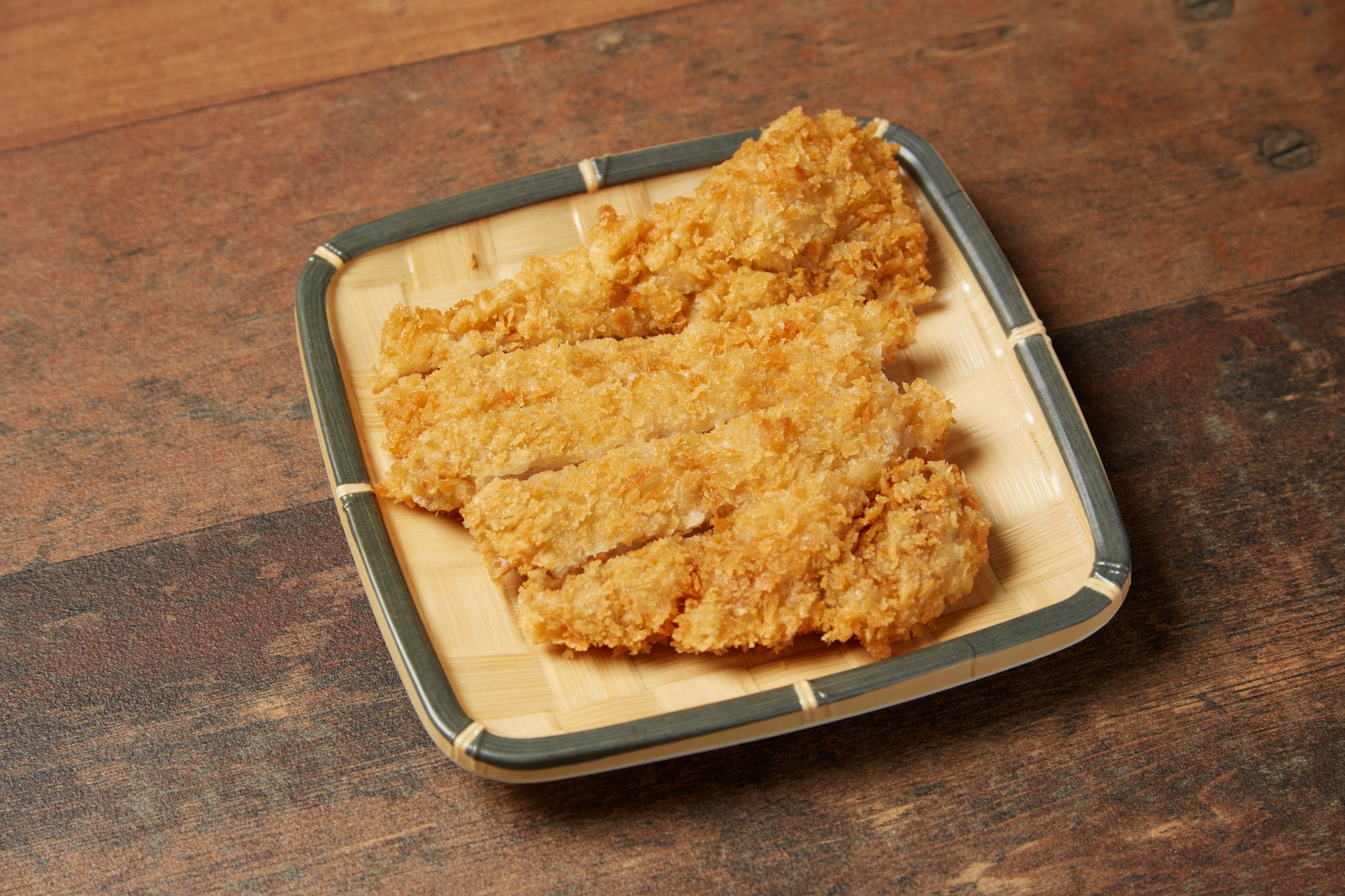 Server pouring aromatic broth over a signature hot pot bowl