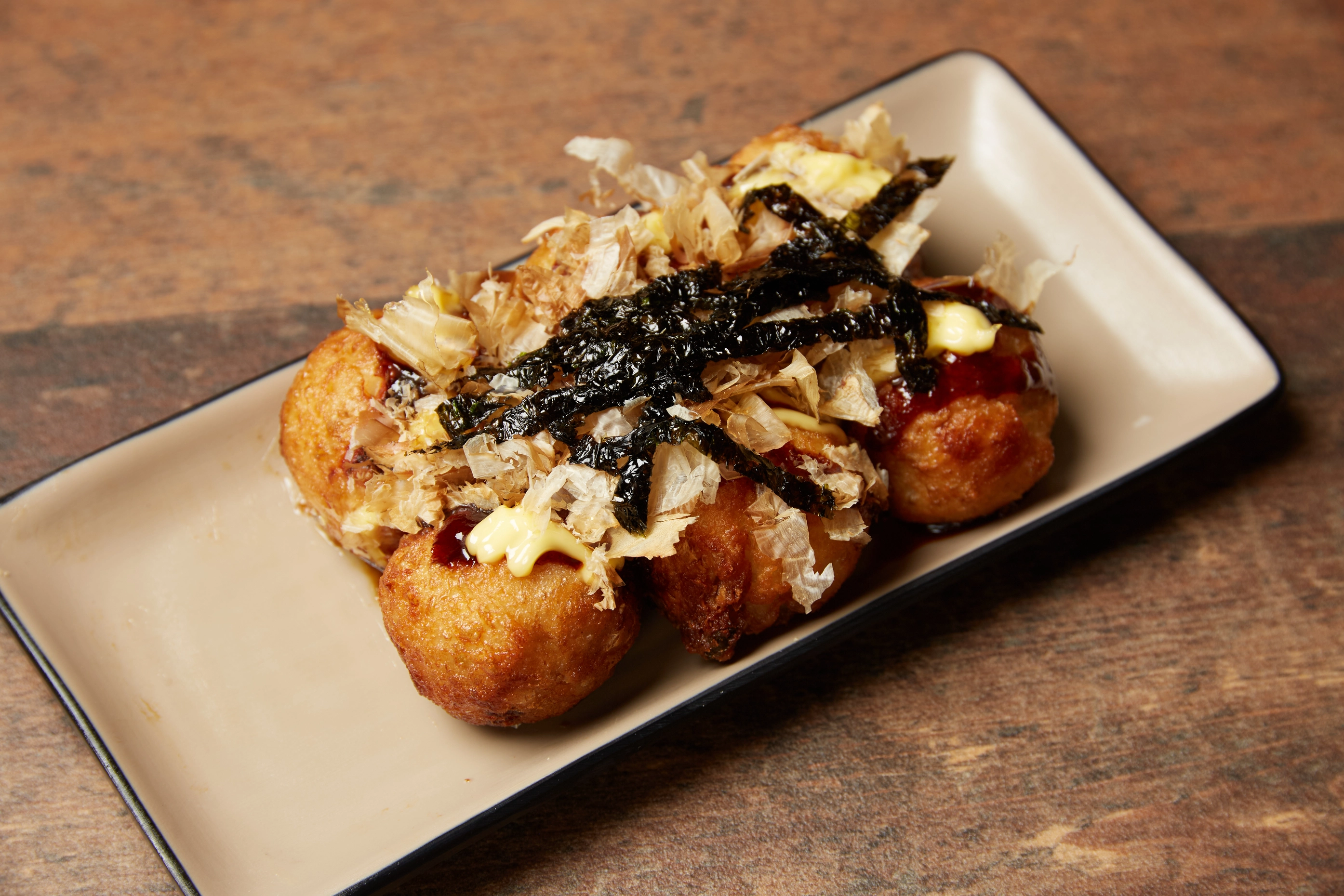 Steaming bowl of soup layered with beef, mushrooms, and herbs