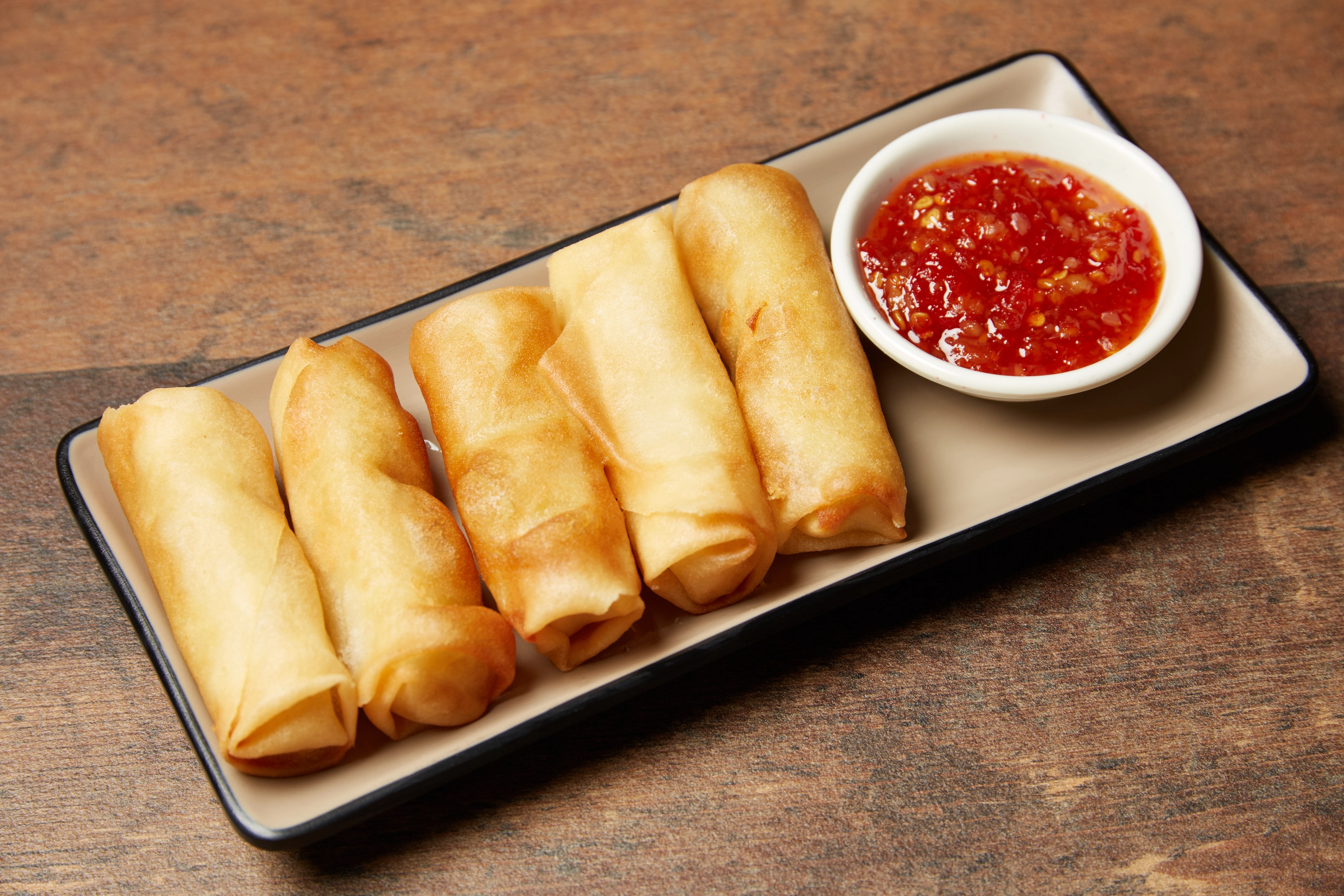 Ladle lifting noodles from a simmering hot pot