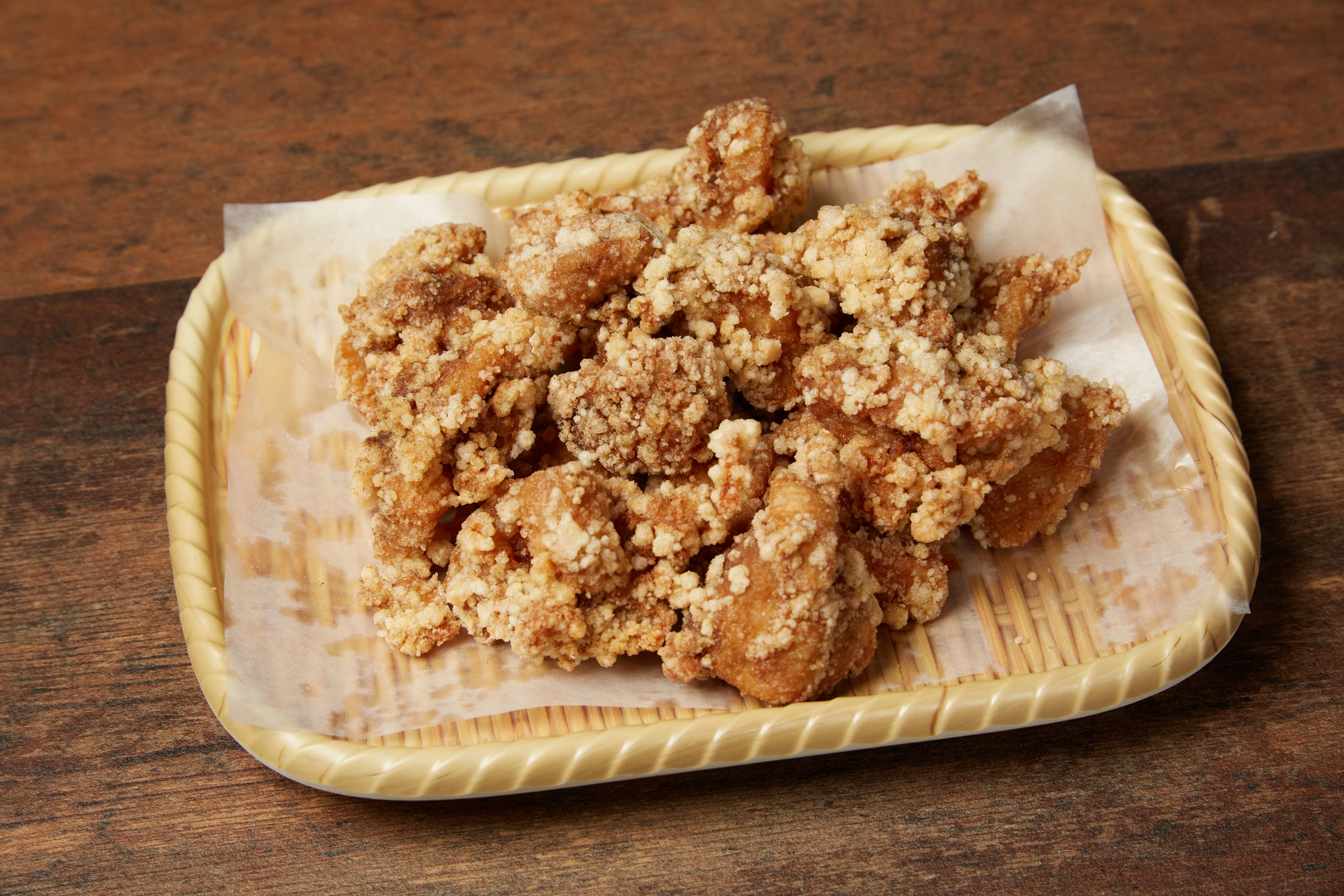 Guest mixing fresh ingredients into a bubbling broth
