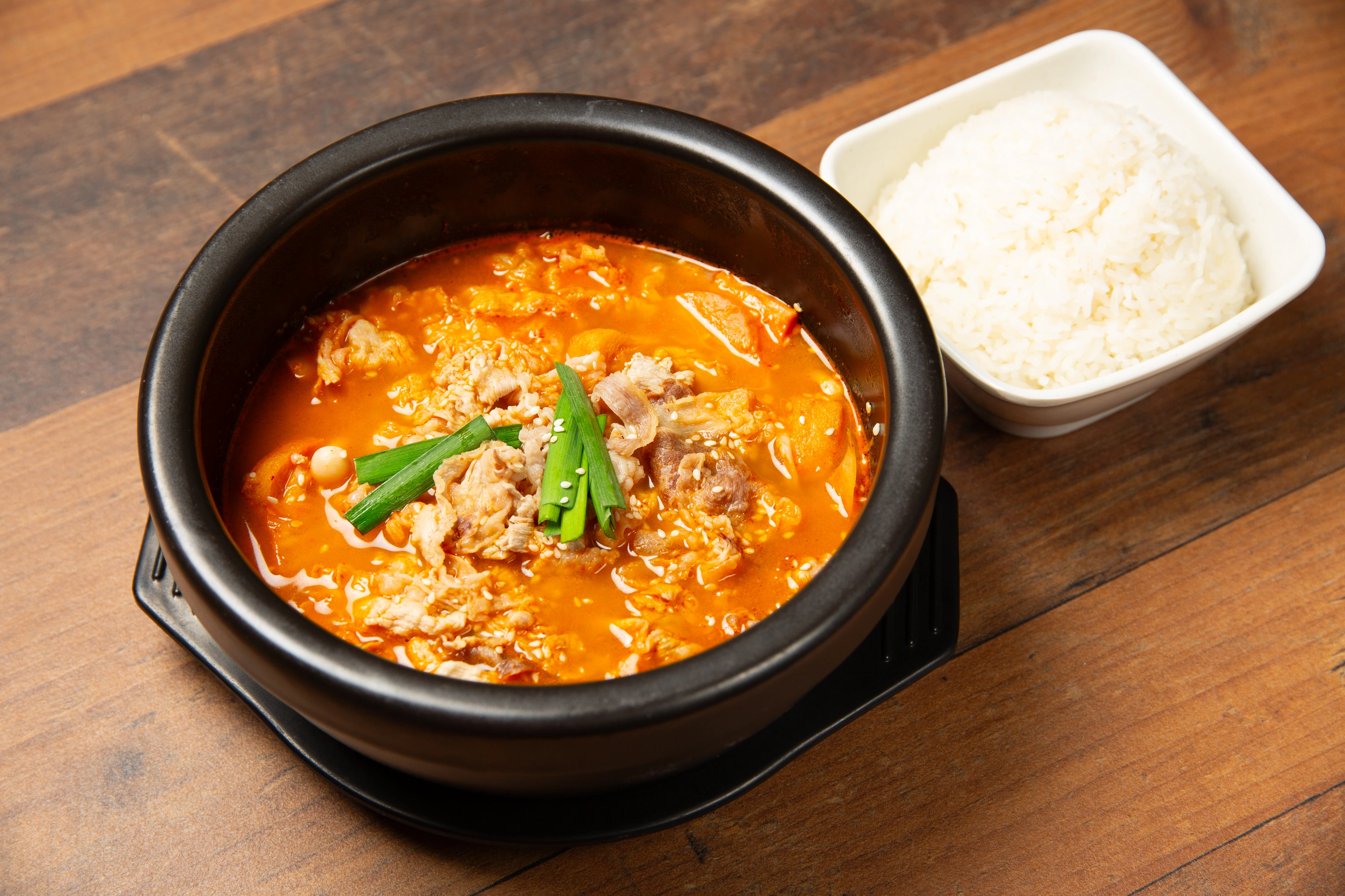 Kimchi fried rice garnished with scallions and sesame seeds